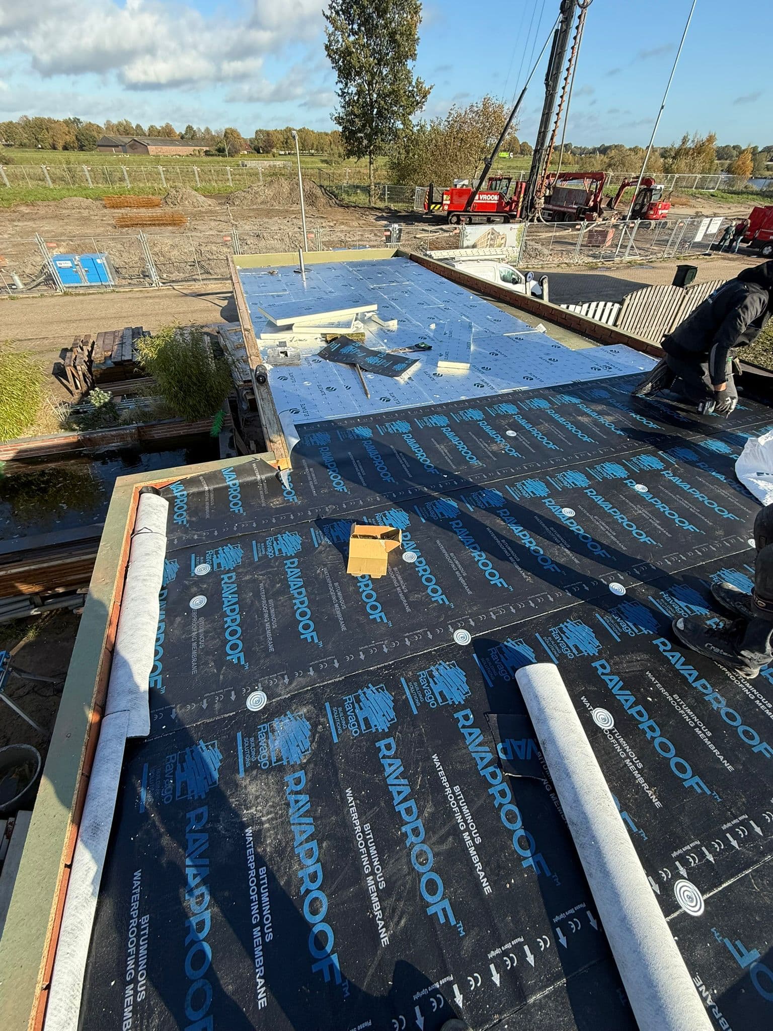 Isolatieplaten met folie op een plat dak tijdens het vervangen van de dakbedekking
